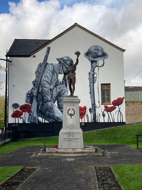 Photograph of the mural painted on the side of the wall next to the war memorial